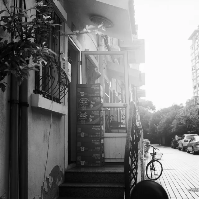 Sunlight falling across a street and building entrance