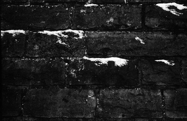 Dark stone steps dotted with small patches of snow