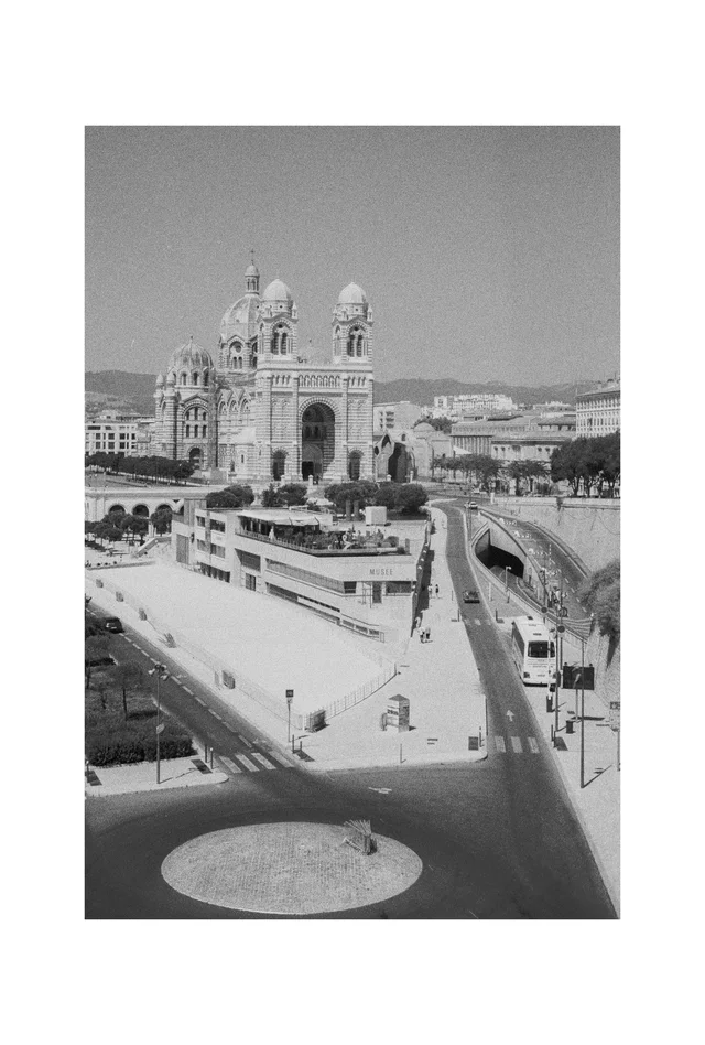 A domed cathedral beyond broad ramps and geometric paved terraces