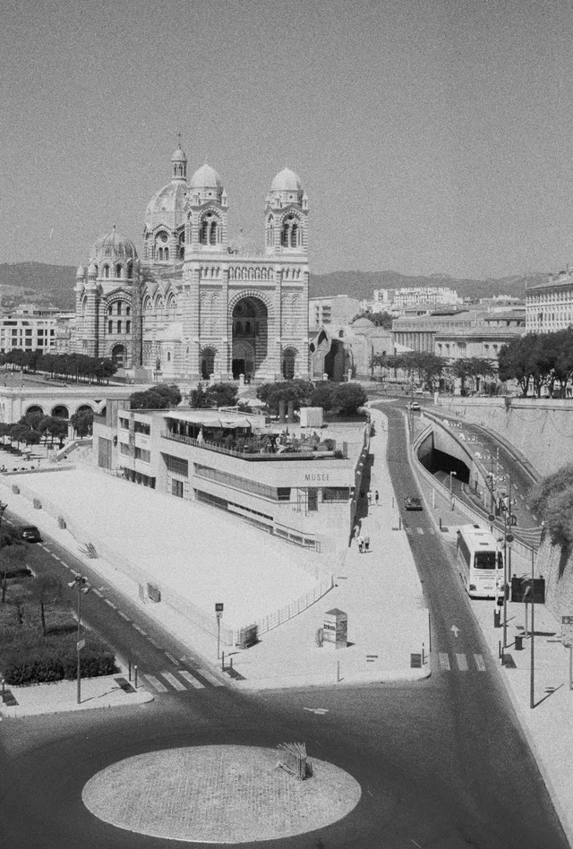 A domed cathedral beyond broad ramps and geometric paved terraces