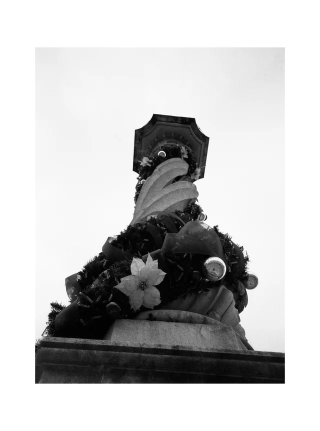 An ornate rooftop chimney decorated with floral and sculpted details