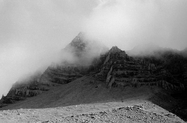 Jagged mountain ridges partly hidden by low mist