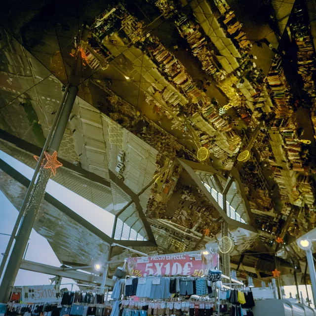 A mirrored golden ceiling above a busy market hall